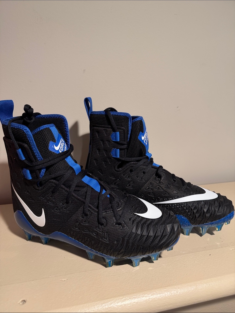 Nike Kids Black and Blue Football Cleats with White Swoosh